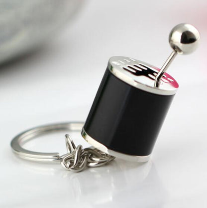 Black and silver mini gear shift keychain with a unique metallic design on a white background metallic design on a white background