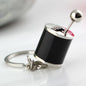Black and silver mini gear shift keychain with a unique metallic design on a white background metallic design on a white background